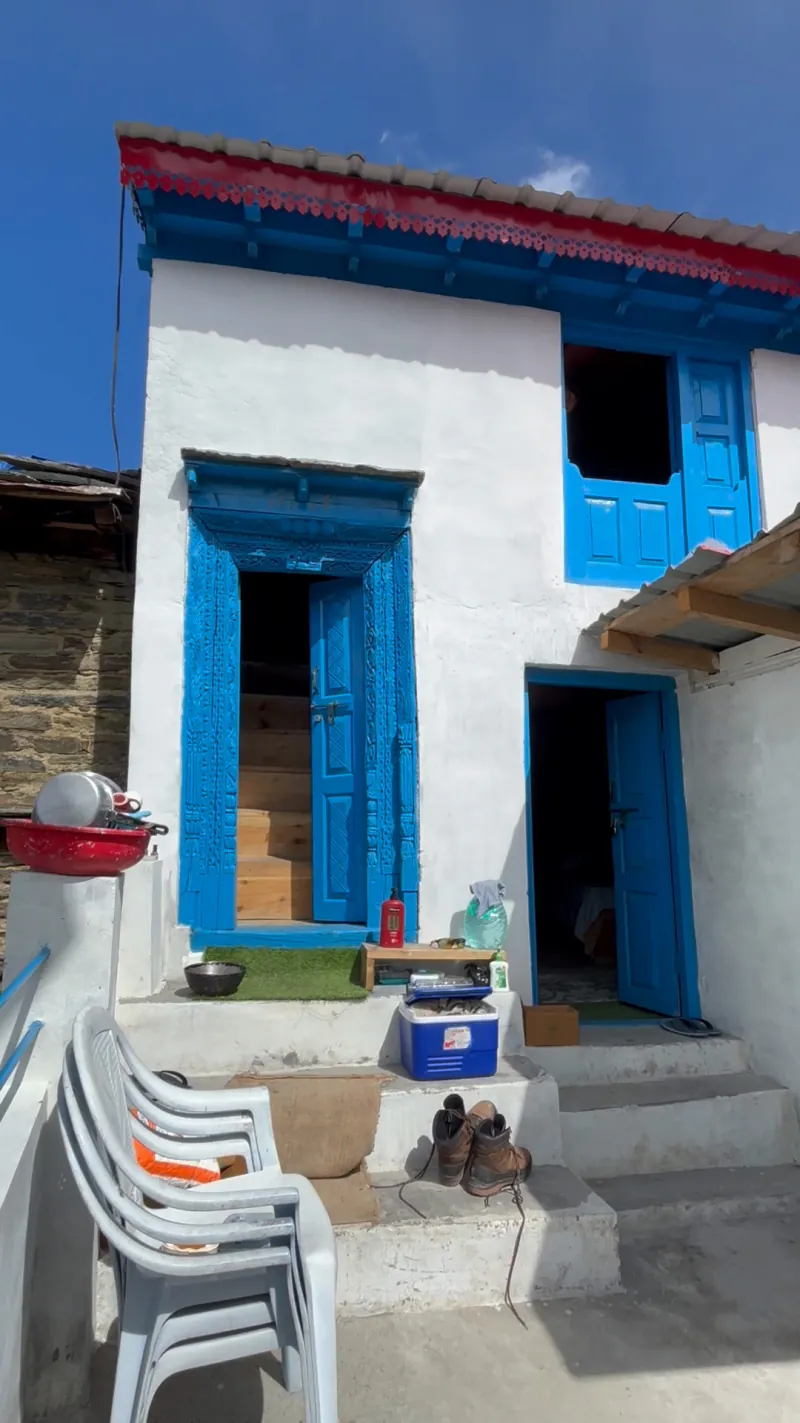 The front of Mati's house: a carved blue door and blue windows
